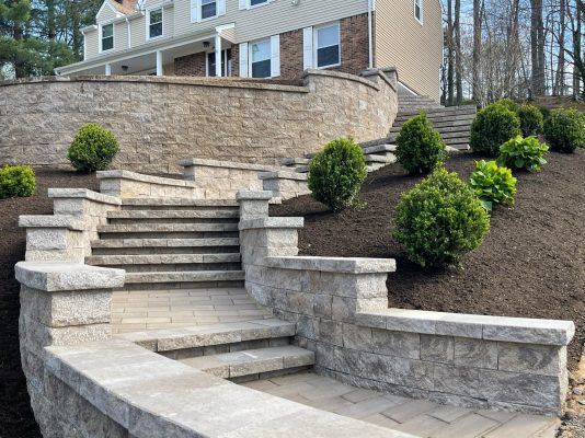 This image showcases Scenic View Landscaping’s precision in creating stone stairways and retaining walls, enhancing this home’s landscape architecture.