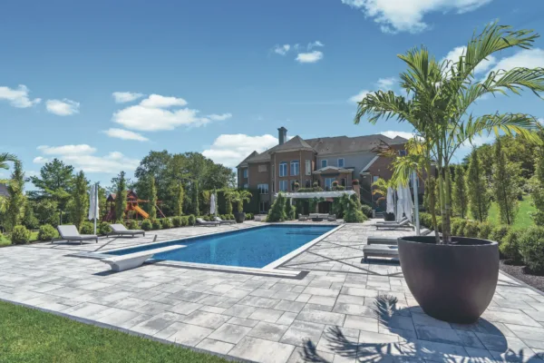 Showcasing Scenic View Landscaping's precision in poolside paving and lush garden design.