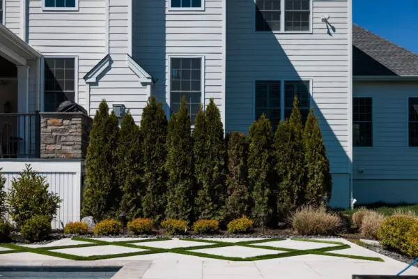 Explore this complete backyard transformation in Lincroft, NJ, by Scenic View Landscaping, featuring detailed landscaping, elegant hardscaping, lush turf inlay, and strategic outdoor lighting. See how we create luxurious, functional outdoor living spaces.