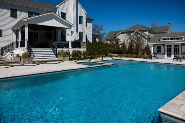 Explore this complete backyard transformation in Lincroft, NJ, by Scenic View Landscaping, featuring detailed landscaping, elegant hardscaping, lush turf inlay, and strategic outdoor lighting. See how we create luxurious, functional outdoor living spaces.
