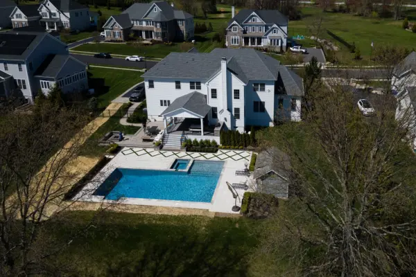 Explore this complete backyard transformation in Lincroft, NJ, by Scenic View Landscaping, featuring detailed landscaping, elegant hardscaping, lush turf inlay, and strategic outdoor lighting. See how we create luxurious, functional outdoor living spaces.