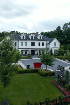A full backyard transformation in Colts Neck, NJ featuring a custom inground pool, elegant hardscaping, colorful landscaping, and a private putting green — designed and built by Scenic View Landscaping.