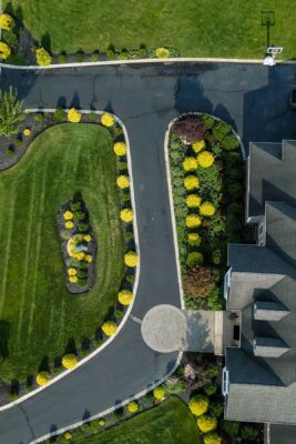 Complete outdoor living makeover in Colts Neck, NJ featuring a custom pool, raised patio, landscape lighting, sod lawn, outdoor kitchen, fire feature, and fully integrated landscape and hardscape design by Scenic View Landscaping.