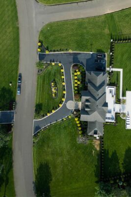Complete outdoor living makeover in Colts Neck, NJ featuring a custom pool, raised patio, landscape lighting, sod lawn, outdoor kitchen, fire feature, and fully integrated landscape and hardscape design by Scenic View Landscaping.