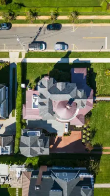 Scenic View Landscaping transformed a Spring Lake property with a complete front and backyard renovation, featuring beach-inspired landscaping, custom lighting, bluestone patio, brick driveway, outdoor kitchen, new sod, drainage, and concrete walkways.