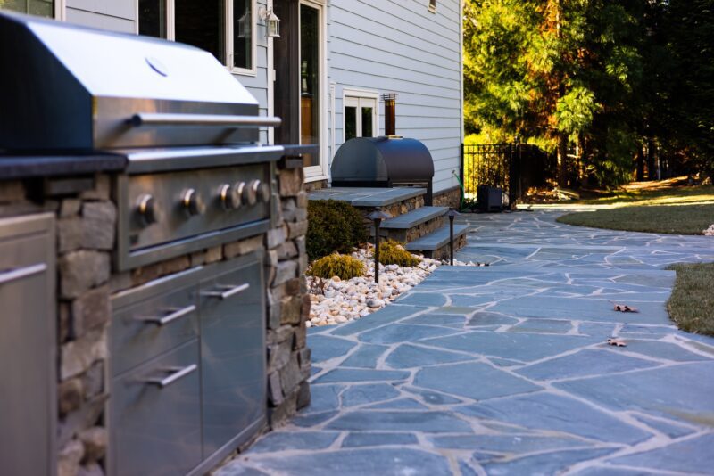 Natural bluestone patio with built in outdoor kitchen installed by Scenic View Landscaping in Monmouth County NJ