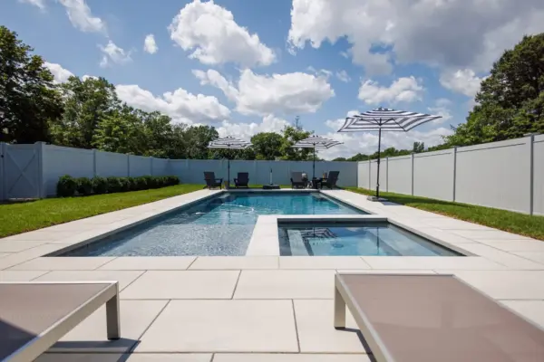 Outdoor living project in Rumson, NJ featuring a covered paver patio, outdoor kitchen, stone steps, natural stone walkway, and fire pit area.